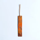 Copper bookmark with cream leather tassel. 